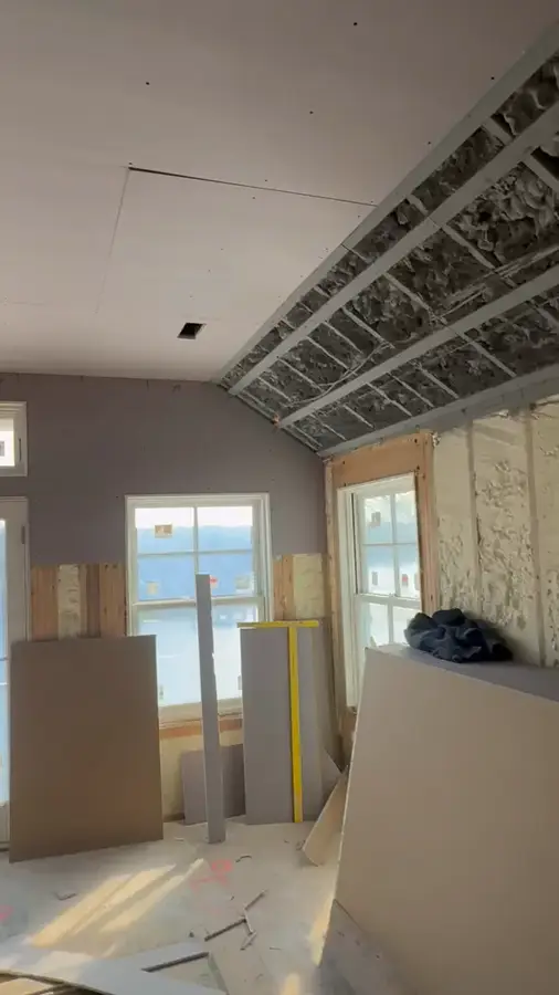 New drywall panels installed and clipped into place in a Massachusetts home