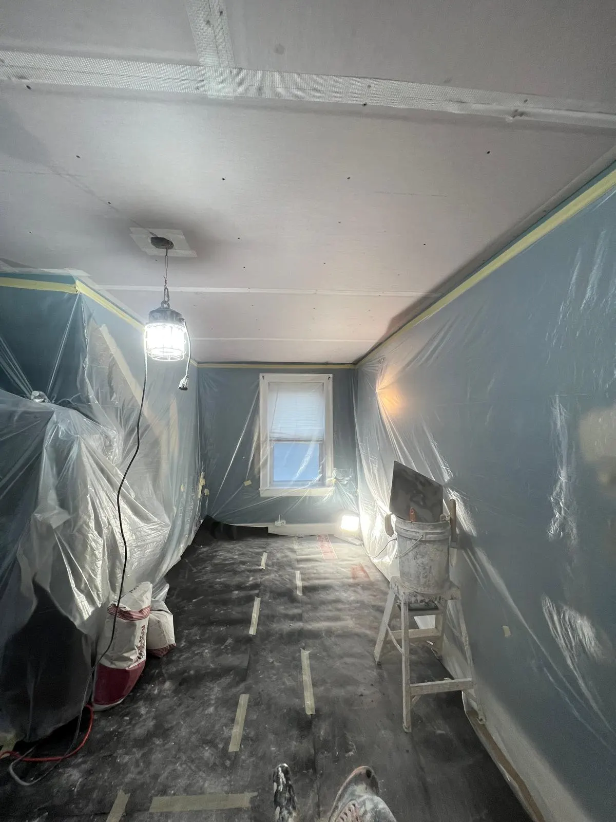 A room masked and prepped for plastering work
