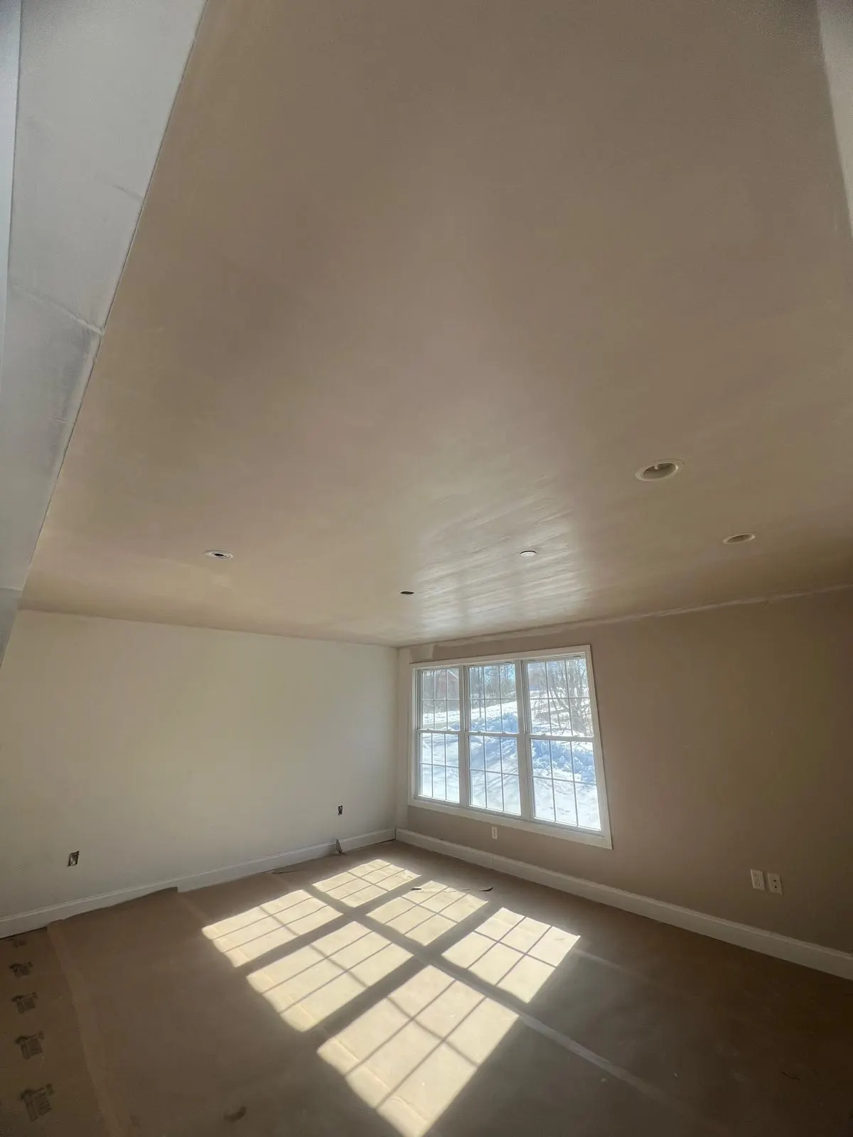 Smooth veneer plaster finish on the walls of a dormer room